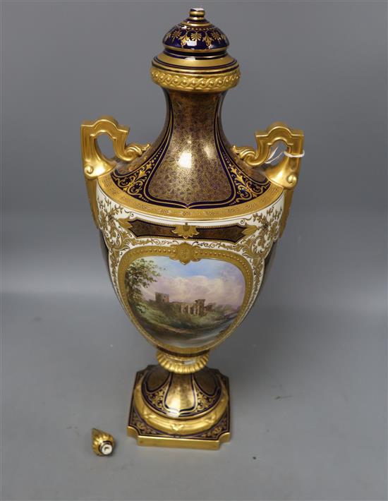 A large Coalport two handled vase and cover, painted with a scene of Balmoral Castle, height 50cm, repairs